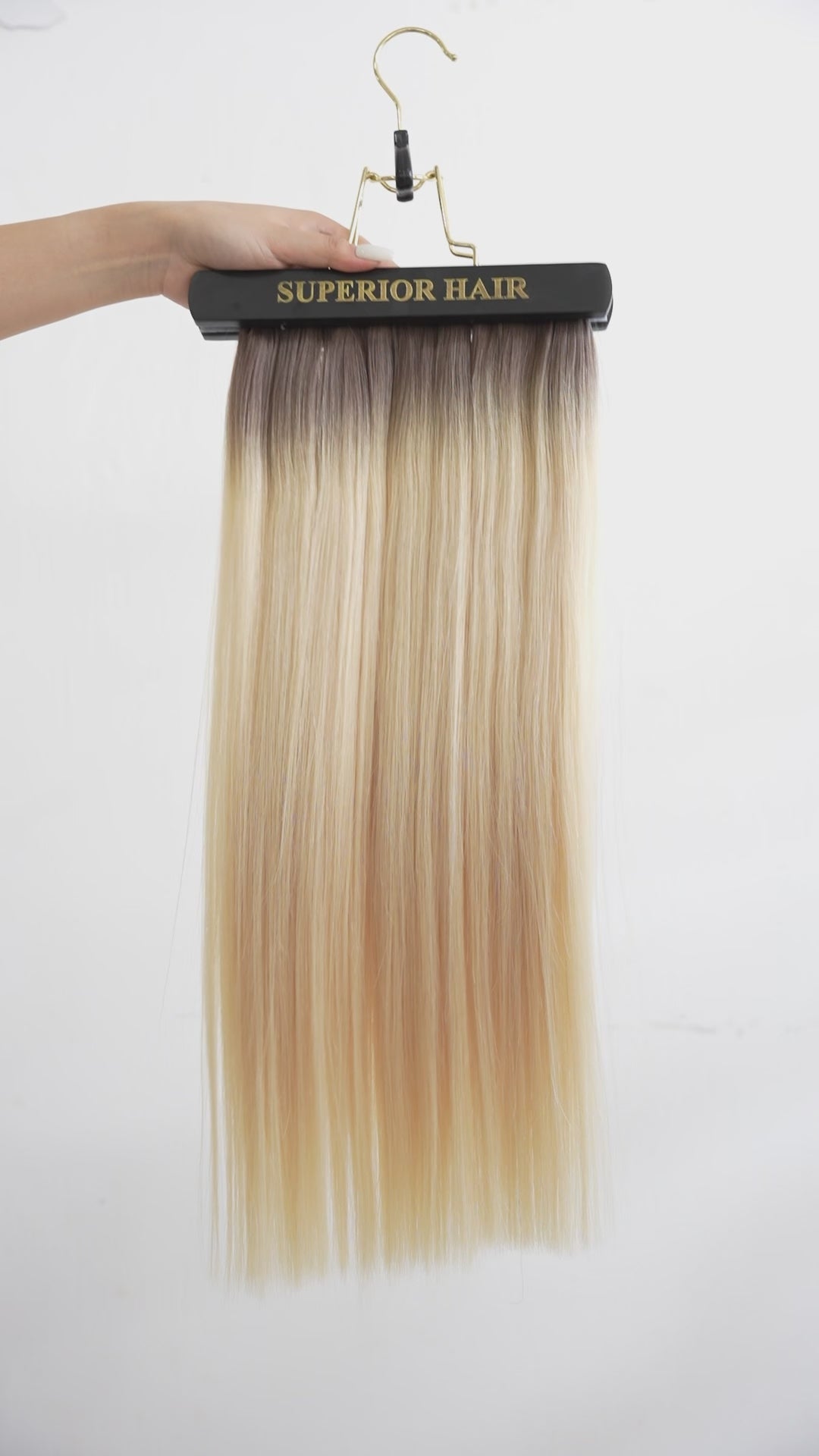 Load video: #Rooted Hollywood Blonde Seamless Tape In Hair Extensions (NEW)